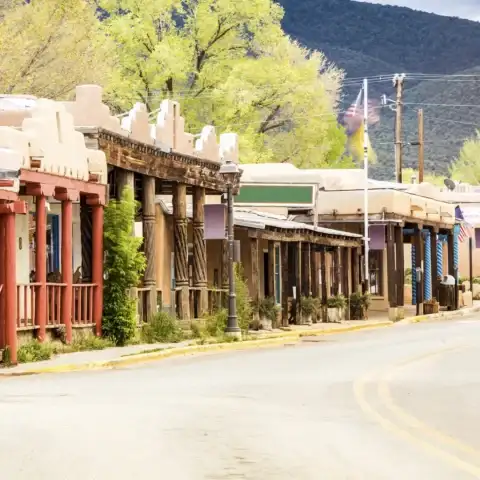 Adobe-style storefronts along a street in Taos, New Mexico.