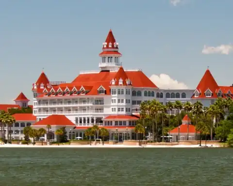 Disney's Grand Floridian Resort and Spa seen from across Seven Seas Lagoon, a Deluxe resort category example.
